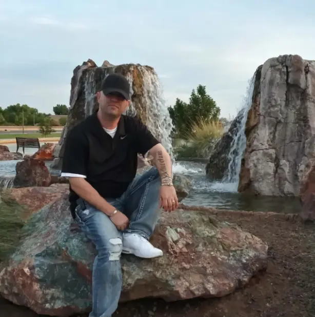 Daniel Kelly sitting on a rock