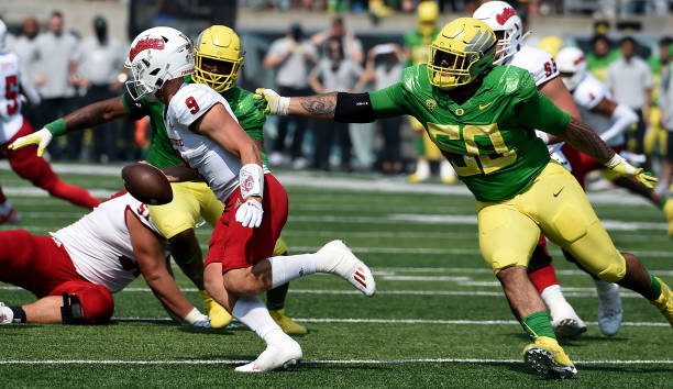 EUGENE, OREGON - SEPTEMBER 04: Quarterback Jake Haener #9 of the Fresno State Bulldogs avoids the rush of defensive tackle Popo Aumavae #50 of the Oregon Ducks during the first quarter of the game at Autzen Stadium on September 04, 2021 in Eugene, Oregon. Oregon won 31-24. (Photo by Steve Dykes/Getty Images)