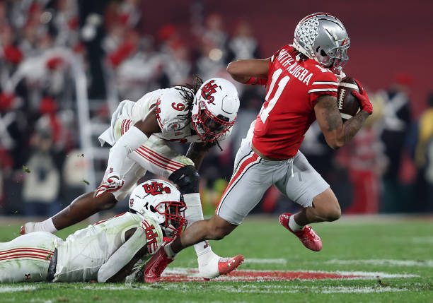 PASADENA, CALIFORNIA - JANUARY 01: Jaxon Smith-Njigba #11 of the Ohio State Buckeyes eludes the tackle of Vonte Davis #9 of the Utah Utes during the second half of the Rose Bowl game at Rose Bowl Stadium on January 01, 2022 in Pasadena, California. (Photo by Sean M. Haffey/Getty Images)