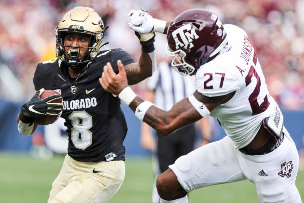 DENVER, CO - SEPTEMBER 11: Alex Fontenot #8 of the Colorado Buffaloes makes a run while being defended by Antonio Johnson #27 of the Texas A&amp;M Aggies during the second quarter at Empower Field At Mile High on September 11, 2021 in Denver, Colorado. (Photo by Michael Ciaglo/Getty Images)