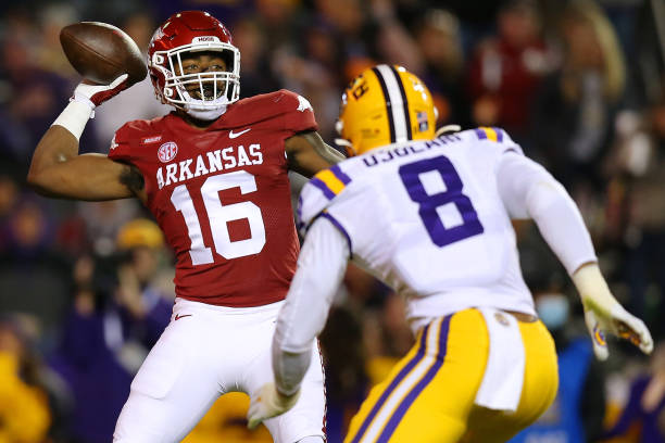 BATON ROUGE, LOUISIANA - NOVEMBER 13: Treylon Burks #16 of the Arkansas Razorbacks throws the ball as BJ Ojulari #8 of the LSU Tigers defends during the fist half of a game at Tiger Stadium on November 13, 2021 in Baton Rouge, Louisiana. (Photo by Jonathan Bachman/Getty Images)