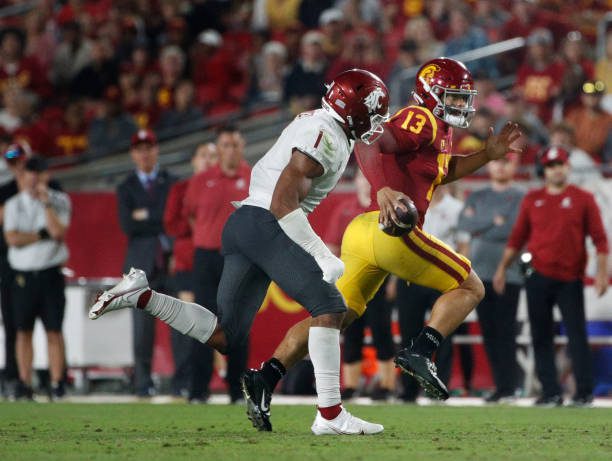 LOS ANGELES, CA - OCTOBER 8, 2022: USC Trojans quarterback Caleb Williams (13) runs for extra yardage against Washington State Cougars linebacker Daiyan Henley (1) at the Coliseum on October 8, 2022 in Los Angeles, California.(Gina Ferazzi / Los Angeles Times via Getty Images)