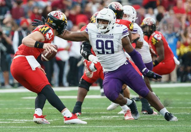 COLLEGE PARK, MD - OCTOBER 22:  Northwestern Wildcats defensive lineman Adetomiwa Adebawore (99) goes after Maryland Terrapins quarterback Billy Edwards Jr. (9) during a Big10 football game between the Maryland Terrapins and the Northwestern Wildcats, on October 22, 2022, at SECU Stadium, in College Park, Maryland. (Photo by Tony Quinn/Icon Sportswire via Getty Images)
