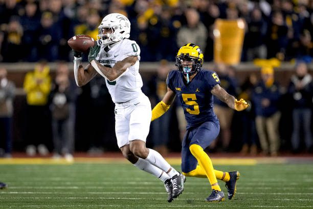 ANN ARBOR, MICHIGAN - OCTOBER 29: Keon Coleman #0 of the Michigan State Spartans receives a pass against DJ Turner #5 of the Michigan Wolverines during the second quarter at Michigan Stadium on October 29, 2022 in Ann Arbor, Michigan. (Photo by Nic Antaya/Getty Images)