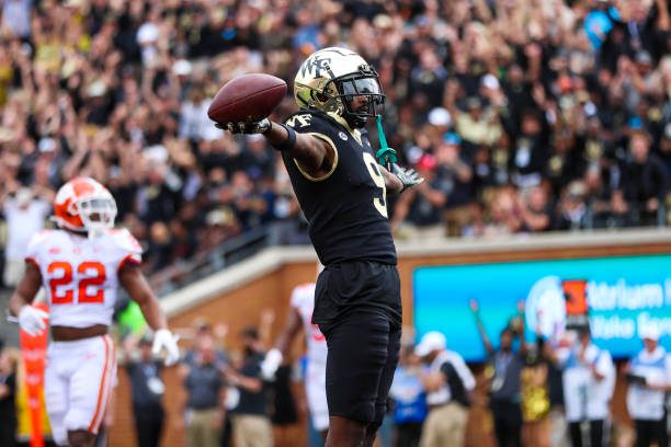 WINSTON-SALEM, NC - SEPTEMBER 24: A.T. Perry (9) of the Wake Forest Demon Deacons celebrates after scoring a touch down during a football game between the Wake Forest Demon Deacons and the Clemson Tigers on September 24, 2022, at Truist Field in Winston-Salem, NC. (Photo by David Jensen/Icon Sportswire via Getty Images)