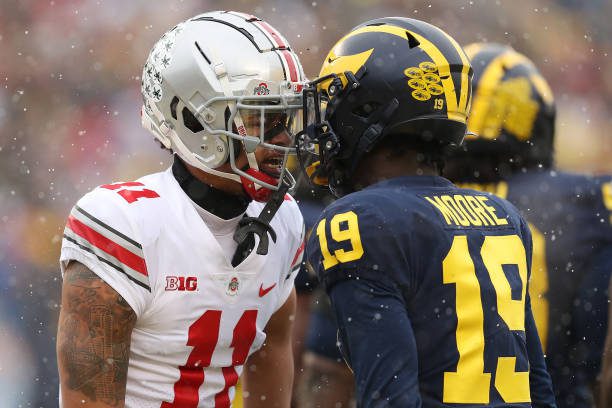 ANN ARBOR, MICHIGAN - NOVEMBER 27: Jaxon Smith-Njigba #11 of the Ohio State Buckeyes and Rod Moore #19 of the Michigan Wolverines talk during the first quarter at Michigan Stadium on November 27, 2021 in Ann Arbor, Michigan. (Photo by Mike Mulholland/Getty Images)