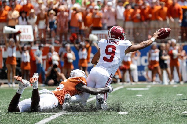 AUSTIN, TEXAS - SEPTEMBER 10: Bryce Young #9 of the Alabama Crimson Tide avoids a sack by Ryan Watts #6 of the Texas Longhorns in the third quarter at Darrell K Royal-Texas Memorial Stadium on September 10, 2022 in Austin, Texas. (Photo by Tim Warner/Getty Images)