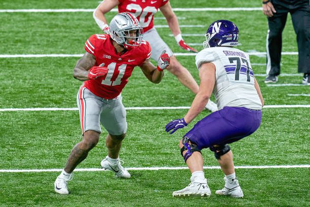 INDIANAPOLIS, IN - DECEMBER 19: Ohio State Buckeyes defensive end Tyreke Smith (11) battles with Northwestern Wildcats offensive lineman Peter Skoronski (77) in action during the Big Ten Championship game between the Ohio State Buckeyes and the Northwestern Wildcats on December 19, 2020 at Lucas Oil stadium, in Indianapolis, IN. (Photo by Robin Alam/Icon Sportswire via Getty Images)