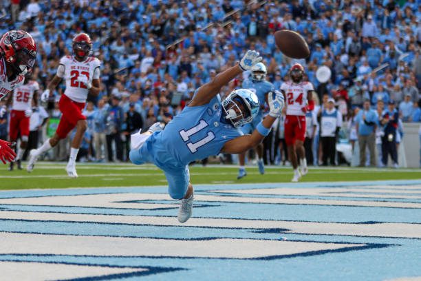 CHAPEL HILL, NC - NOVEMBER 25: Josh Downs (11) of the North Carolina Tar Heels dives in attempt to catch a pass during a football game between the North Carolina Tar Heels and the North Carolina State Wolfpack on Nov 25, 2022 at Kenan Memorial Stadium in Chapel Hill, NC. (Photo by David Jensen/Icon Sportswire via Getty Images)