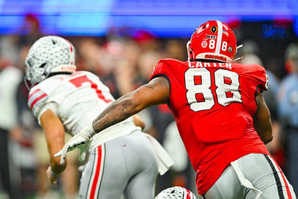ATLANTA, GA  DECEMBER 31:  Georgia defensive lineman Jalen Carter (88) chases Ohio State quarterback C.J. Stroud (7) during the Chick-fil-A Peach Bowl college football playoff game between the Ohio State Buckeyes and the Georgia Bulldogs on December 31st, 2022 at Mercedes-Benz Stadium in Atlanta, GA.  (Photo by Rich von Biberstein/Icon Sportswire via Getty Images)