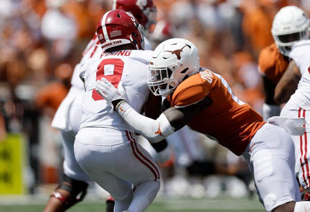 AUSTIN, TEXAS - SEPTEMBER 10: DeMarvion Overshown #0 of the Texas Longhorns hits Bryce Young #9 of the Alabama Crimson Tide in the fourth quarter at Darrell K Royal-Texas Memorial Stadium on September 10, 2022 in Austin, Texas. (Photo by Tim Warner/Getty Images)
