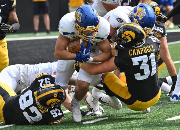 IOWA CITY, IA - SEPTEMBER 03: South Dakota State running back Isiah Davis (22) is tackled by Iowa middle linebacker Jack Campbell (31)during a college football game between the South Dakota State Jackrabbits and the Iowa Hawkeyes, September 03, 2022, at Kinnick Stadium, Iowa City, IA. Photo by Keith Gillett/Icon Sportswire via Getty Images),