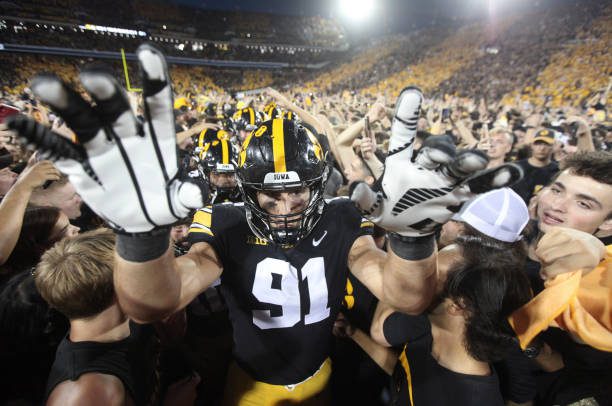 IOWA CITY, IOWA- OCTOBER 9:  Defensive lineman Lukas Van Ness #91 of the Iowa Hawkeyes celebrates with fans after the match-up against the Penn State Nittany Lions at Kinnick Stadium on October 9, 2021 in Iowa City, Iowa.  (Photo by Matthew Holst/Getty Images)