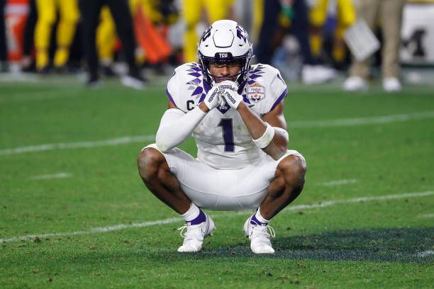 GLENDALE, AZ - DECEMBER 31:  TCU Horned Frogs wide receiver Quentin Johnston (1) prays on the field while waiting for a replay review during the VRBO Fiesta Bowl college football national championship semifinal game between the Michigan Wolverines and the TCU Horned Frogs on December 31, 2022 at State Farm Stadium in Glendale, Arizona. (Photo by Kevin Abele/Icon Sportswire via Getty Images)