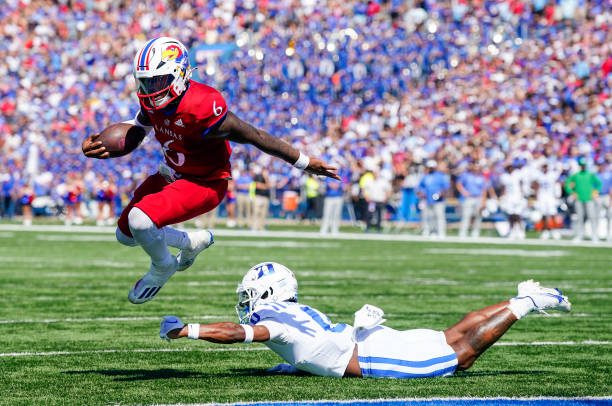 LAWRENCE, KS - SEPTEMBER 24: Jalon Daniels #6 of the Kansas Jayhawks runs for a touchdown past Chandler Rivers #0 of the Duke Blue Devils during the second half at David Booth Kansas Memorial Stadium on September 24, 2022 in Lawrence, Kansas. Kansas defeated Duke 35-27. (Photo by Jay Biggerstaff/Getty Images)