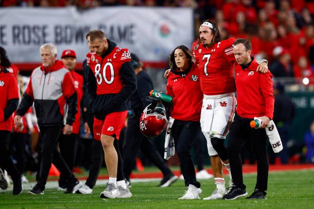 PASADENA, CALIFORNIA - JANUARY 02: Cameron Rising #7 of the Utah Utes is assisted off the field after being injured in a play against the Penn State Nittany Lions during the third quarter in the 2023 Rose Bowl Game at Rose Bowl Stadium on January 02, 2023 in Pasadena, California. (Photo by Ronald Martinez/Getty Images)