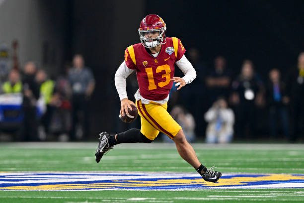 ARLINGTON, TEXAS - JANUARY 02: Quarterback Caleb Williams #13 of the USC Trojans rolls out of the pocket during the second quarter of the Goodyear Cotton Bowl Classic football game against the Tulane Green Wave at AT&amp;T Stadium on January 02, 2023 in Arlington, Texas. (Photo by Alika Jenner/Getty Images)