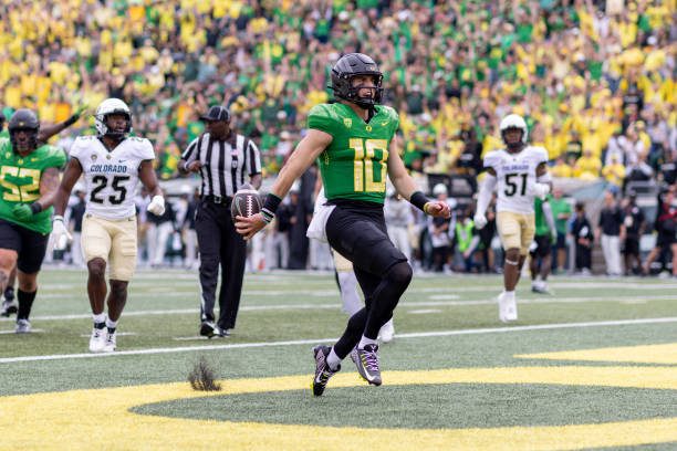 EUGENE, OREGON - SEPTEMBER 23: Quarterback Bo Nix #10 of the Oregon Ducks runs for a touchdown against the Colorado Buffaloes during the first half at Autzen Stadium on September 23, 2023 in Eugene, Oregon. (Photo by Tom Hauck/Getty Images)