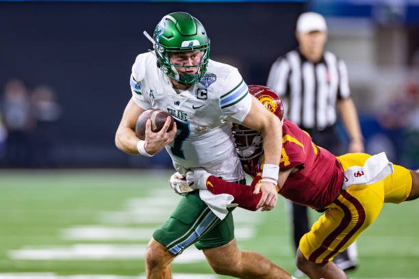 ARLINGTON, TX - JANUARY 02: Tulane Green Wave quarterback Michael Pratt (#7) tries to break away from USC Trojans defensive back Max Williams (#4) during the Goodyear Cotton Bowl game between the USC Trojans and Tulane Green Wave on January 02, 2023 at AT&amp;T Stadium in Arlington, TX.  (Photo by Matthew Visinsky/Icon Sportswire via Getty Images)
