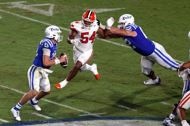 DURHAM, NORTH CAROLINA - SEPTEMBER 04: Jeremiah Trotter Jr. #54 of the Clemson Tigers gets past Graham Barton #62 of the Duke Blue Devils at Wallace Wade Stadium on September 4, 2023 in Durham, North Carolina. Duke won 28-7. (Photo by Lance King/Getty Images)