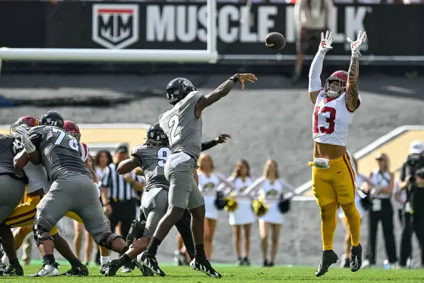 BOULDER, CO - SEPTEMBER 30: Mason Cobb #13 of the USC Trojans bats down a pass attempt by Shedeur Sanders #2 of the Colorado Buffaloes in the first quarter of the game at Folsom Field on September 30, 2023 in Boulder, Colorado. (Photo by Dustin Bradford/Getty Images)