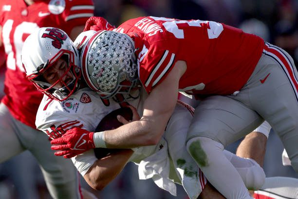 PASADENA, CALIFORNIA - JANUARY 01: Jack Sawyer #33 of the Ohio State Buckeyes is called for targeting after this hit onCameron Rising #7 of the Utah Utes during the first half in the Rose Bowl Game at Rose Bowl Stadium on January 01, 2022 in Pasadena, California. (Photo by Sean M. Haffey/Getty Images)