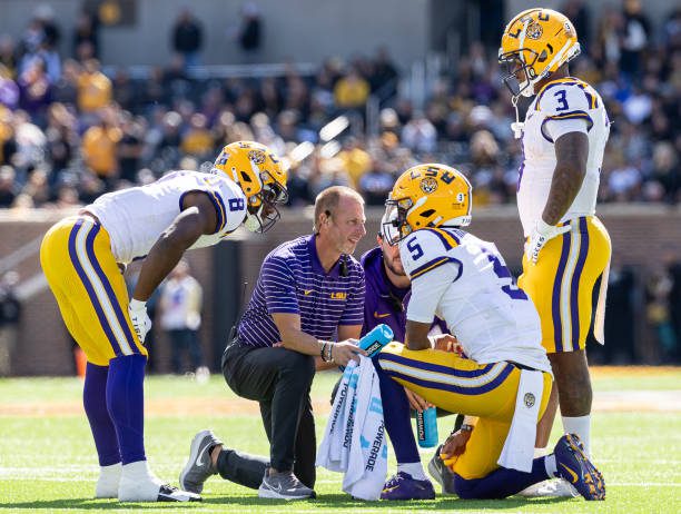 COLUMBIA, MISSOURI - OCTOBER 7:  LSU Tigers trainers attend to Jayden Daniels #5 of the LSU Tigers after an injury during the game against the Missouri Tigers at Faurot Field/Memorial Stadium on October 7, 2023 in Columbia, Missouri. (Photo by Michael Hickey/Getty Images)