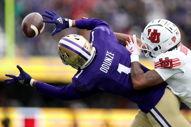 SEATTLE, WASHINGTON - NOVEMBER 11: Rome Odunze #1 of the Washington Huskies can't pull in a catch against JaTravis Broughton #4 of the Utah Utes during the second quarter at Husky Stadium on November 11, 2023 in Seattle, Washington. (Photo by Steph Chambers/Getty Images)