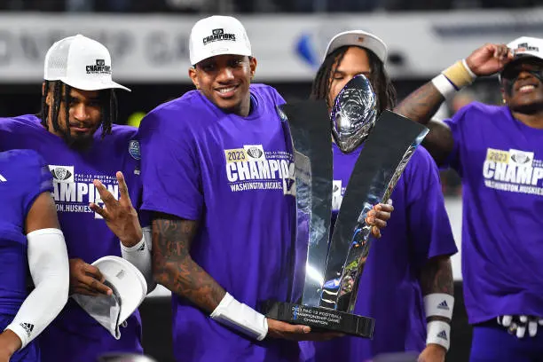 LAS VEGAS, NV - DECEMBER 01: Washington Huskies quarterback Michael Penix Jr. (9) holds up the trophy after the Pac-12 Conference championship game between the Oregon Ducks and the Washington Huskies on December 1, 2023 at Allegiant Stadium in Las Vegas, Nevada. (Photo by Brian Rothmuller/Icon Sportswire via Getty Images)