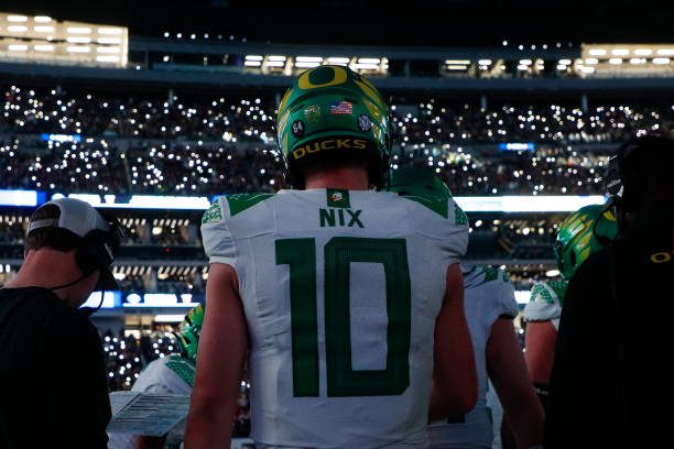 LAS VEGAS, NEVADA - DECEMBER 1: Bo Nix #10 of the Oregon Ducks stands on the sideline in the second half during the Pac-12 Championship game against the Washington Huskies at Allegiant Stadium on December 1, 2023 in Las Vegas, Nevada. (Photo by Brandon Sloter/Image Of Sport/Getty Images)