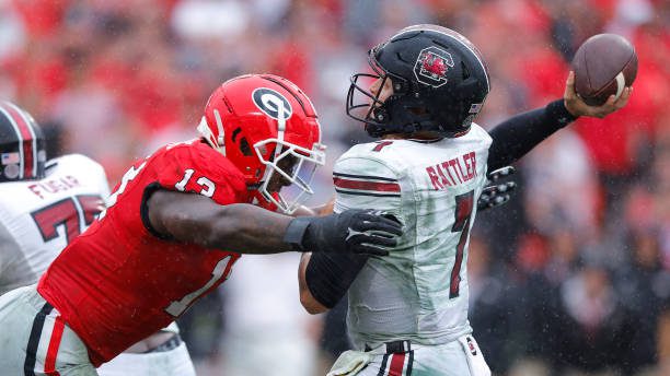 ATHENS, GEORGIA - SEPTEMBER 16: Mykel Williams #13 of the Georgia Bulldogs pressures Spencer Rattler #7 of the South Carolina Gamecocks during the fourth quarter at Sanford Stadium on September 16, 2023 in Athens, Georgia. (Photo by Todd Kirkland/Getty Images)