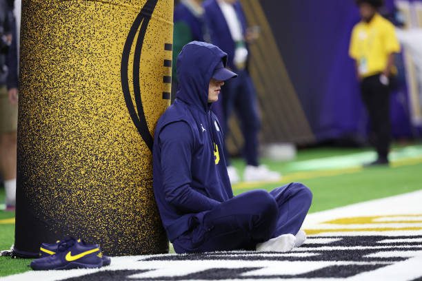 HOUSTON, TEXAS - JANUARY 8: J.J. McCarthy #9 of the Michigan Wolverines looks on prior to the CFP National Championship game at NRG Stadium on January 8, 2024 in Houston, Texas. (Photo by CFP/Getty Images)