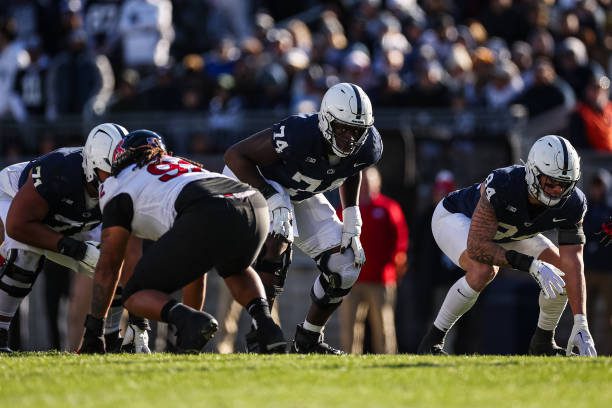 STATE COLLEGE, PA - NOVEMBER 18: Olaivavega Ioane #71, Olumuyiwa Fashanu #74, and Theo Johnson #84 of the Penn State Nittany Lions line up against Mayan Ahanotu #92 of the Rutgers Scarlet Knights during the second half at Beaver Stadium on November 18, 2023 in State College, Pennsylvania. (Photo by Scott Taetsch/Getty Images)