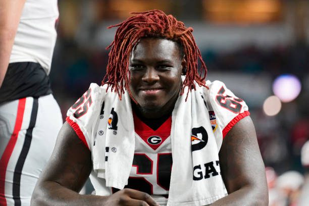 MIAMI GARDENS, FLORIDA - DECEMBER 30: Amarius Mims #65 of the Georgia Bulldogs celebrates after beating the Florida State Seminoles 63-3 to win the Capital One Orange Bowl at Hard Rock Stadium on December 30, 2023 in Miami Gardens, Florida. (Photo by Rich Storry/Getty Images)