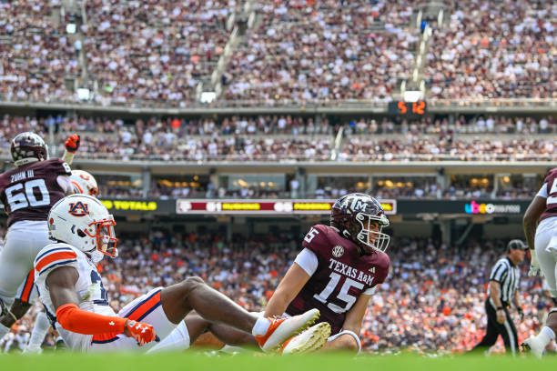 COLLEGE STATION, TX - SEPTEMBER 23: Texas A&amp;M Aggies quarterback Conner Weigman (15) grimaces in pain after taking a hit from Auburn Tigers cornerback Jaylin Simpson (36) just before halftime during the football game between the Auburn Tigers and Texas A&amp;M Aggies at Kyle Field on September 23, 2023, in College Station, Texas. (Photo by Ken Murray/Icon Sportswire via Getty Images)