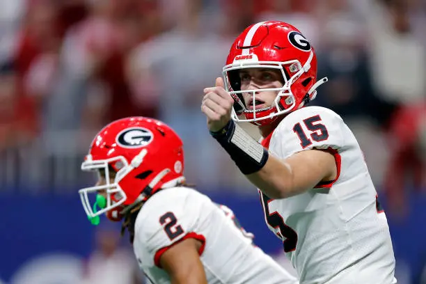 ATLANTA, GEORGIA - DECEMBER 02: Carson Beck #15 of the Georgia Bulldogs signals the play to teammates during the first quarter against the Alabama Crimson Tide in the SEC Championship at Mercedes-Benz Stadium on December 02, 2023 in Atlanta, Georgia. (Photo by Todd Kirkland/Getty Images)