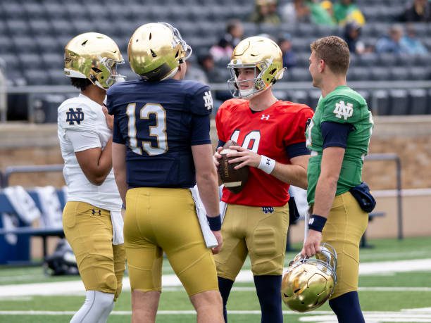 SOUTH BEND, IN - APRIL 20: Notre Dame quarterback Riley Leonard (13) speaks with Notre Dame quarterback Kenny Minchey (8), Notre Dame quarterback Steve Angeli (18), and Notre Dame quarterback CJ Carr (12) before the Notre Dame Spring Game at Notre Dame Stadium on April 20, 2024. (Photo by Joseph Weiser/Icon Sportswire via Getty Images)