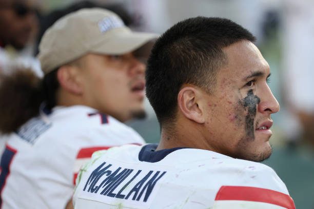 TEMPE, ARIZONA - NOVEMBER 25: Wide receiver Tetairoa McMillan #4 of the Arizona Wildcats sits on the bench during the second half of the NCAAF game against the Arizona State Sun Devils at Mountain America Stadium on November 25, 2023 in Tempe, Arizona. The Wildcats defeated the Sun Devils 59-23. (Photo by Christian Petersen/Getty Images)