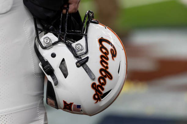 HOUSTON, TX - DECEMBER 27: Oklahoma State Cowboys helmet is held after the TaxAct Texas Bowl between Texas A&amp;M Aggies and Oklahoma State Cowboys on December 27, 2023, at NRG Stadium in Houston, Texas.  (Photo by David Buono/Icon Sportswire via Getty Images)