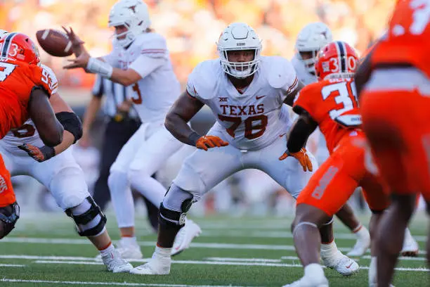 STILLWATER, OK - OCTOBER 22:  Left tackle Kelvin Banks Jr. #78 of the Texas Longhorns blocks for quarterback Quinn Ewers #3 against defensive end Collin Oliver #30 of the Oklahoma State Cowboys in the third quarter at Boone Pickens Stadium on October 22, 2022 in Stillwater, Oklahoma.  Oklahoma State won 41-34.  (Photo by Brian Bahr/Getty Images)