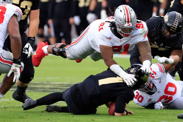 WEST LAFAYETTE, INDIANA - OCTOBER 14: Tyleik Williams #91 of the Ohio State Buckeyes tackles Hudson Card #1 of the Purdue Boilermakers at Ross-Ade Stadium on October 14, 2023 in West Lafayette, Indiana. (Photo by Justin Casterline/Getty Images)