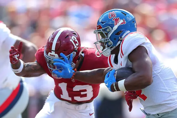 TUSCALOOSA, ALABAMA - SEPTEMBER 23:  Quinshon Judkins #4 of the Mississippi Rebels stiff arms Malachi Moore #13 of the Alabama Crimson Tide during the first quarter at Bryant-Denny Stadium on September 23, 2023 in Tuscaloosa, Alabama. (Photo by Kevin C. Cox/Getty Images)