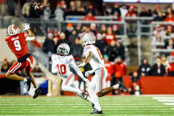 MADISON, WI - OCTOBER 28: Wisconsin wide receiver Bryson Green (9) leaps to catch the ball while Ohio State corner back Denzel Burke (10) and Ohio State safety Sonny Styles (6) look on during a college football game between the University of Wisconsin Badgers and the Ohio State University Buckeyes on October 28, 2023 at Camp Randall Stadium in Madison, WI. (Photo by Lawrence Iles/Icon Sportswire via Getty Images)