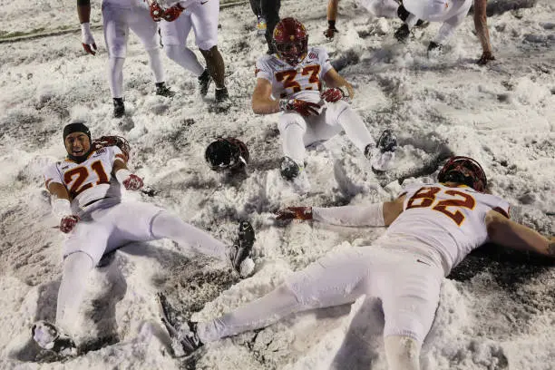 MANHATTAN, KS - NOVEMBER 25: Iowa State Cyclones players celebrate in the snow after a Big 12 football game between the Iowa State Cyclones and Kansas State Wildcats on Nov 25, 2023 at Bill Snyder Family Stadium in Manhattan, KS. (Photo by Scott Winters/Icon Sportswire via Getty Images)