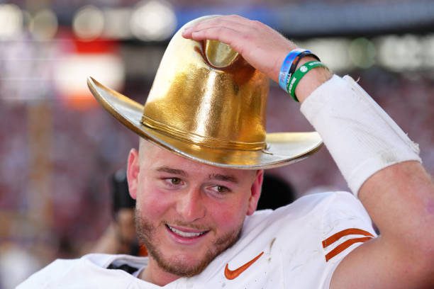 DALLAS, TEXAS - OCTOBER 12: Quinn Ewers #3 of the Texas Longhorns wears the Golden Hat Trophy after defeating the Oklahoma Sooners 34-3 at Cotton Bowl Stadium on October 12, 2024 in Dallas, Texas. (Photo by Sam Hodde/Getty Images)