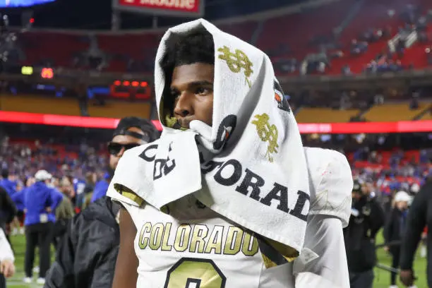 KANSAS CITY, MO - NOVEMBER 23: Colorado Buffaloes quarterback Shedeur Sanders (2) walks off the field with a towel over his head after a Big 12 game between the Colorado Buffaloes and Kansas Jayhawks on November 23, 2024 at GEHA Field at Arrowhead Stadium in Kansas City, MO. (Photo by Scott Winters/Icon Sportswire via Getty Images)