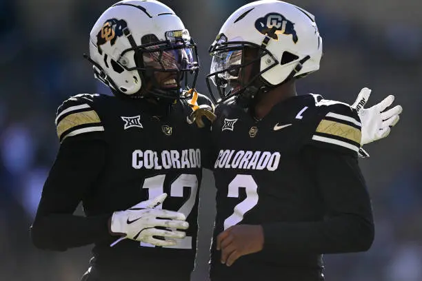 BOULDER, CO - NOVEMBER 29:  Shedeur Sanders #2 and Travis Hunter #12 of the Colorado Buffaloes celebrate after a third quarter touchdown against the Oklahoma State Cowboys at Folsom Field on November 29, 2024 in Boulder, Colorado. (Photo by Dustin Bradford/Getty Images)