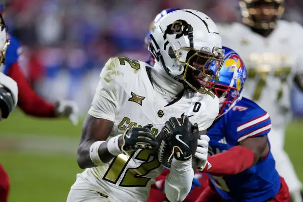 KANSAS CITY, MISSOURI - NOVEMBER 23: Wide receiver Travis Hunter #12 of the Colorado Buffaloes runs in the second half against the Kansas Jayhawks at Arrowhead Stadium on November 23, 2024 in Kansas City, Missouri.  (Photo by Ed Zurga/Getty Images)