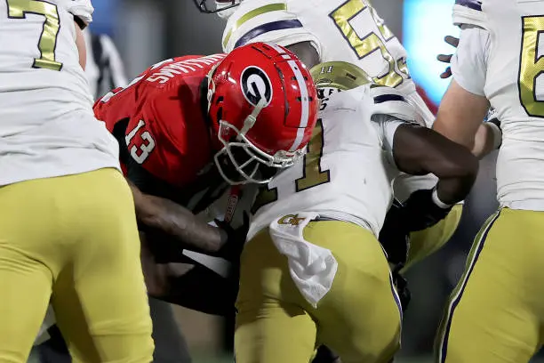 ATHENS, GA - NOVEMBER 29: Georgia Bulldogs defensive lineman Mykel Williams #13 tackles Georgia Tech Yellow Jackets running back Jamal Haynes #11 during the Friday evening college football game between the Georgia Bulldogs and the Georgia Tech Yellow Jackets on November 29, 2024 on Dooley Field at Sanford Stadium in Athens, Georgia.  (Photo by David J. Griffin/Icon Sportswire via Getty Images)