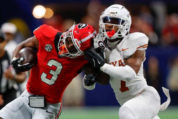 ATLANTA, GEORGIA - DECEMBER 7: Nate Frazier #3 of the Georgia Bulldogs is knocked out of bounds by Jahdae Barron #7 of the Texas Longhorns during the fourth quarter in the 2024 SEC Championship at Mercedes-Benz Stadium on December 7, 2024 in Atlanta, Georgia. (Photo by Todd Kirkland/Getty Images)